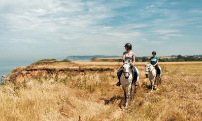 Riders on the Normandy coast near Étretat