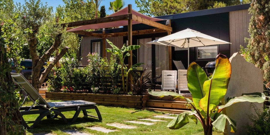 Mobile home with a patio at a luxury campground